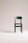 green wooden chair on white surface